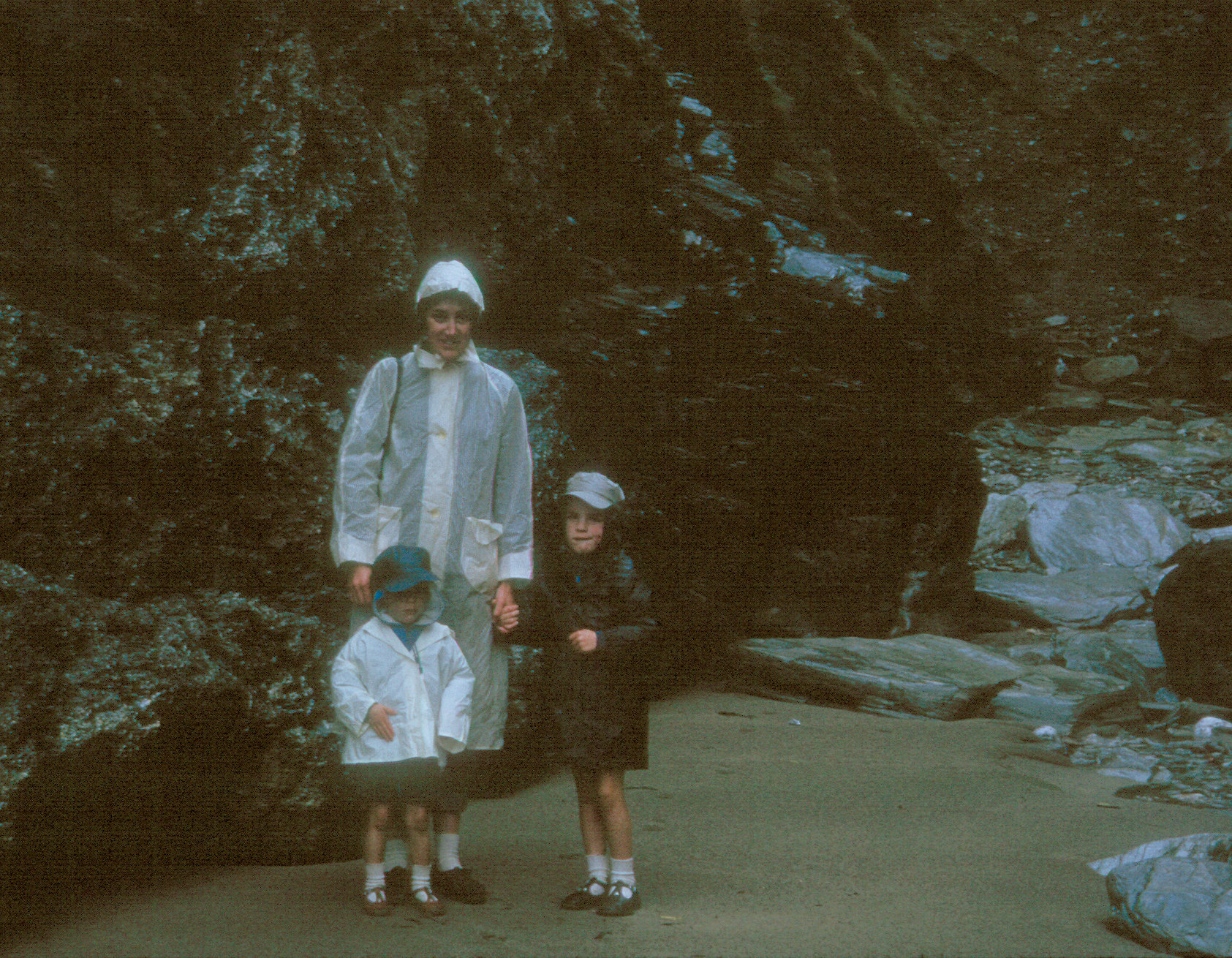 6801705k May 1968 - Our trip to Tintagel was spoilt by rain! Betty, Simon and Jonathan on the beach.