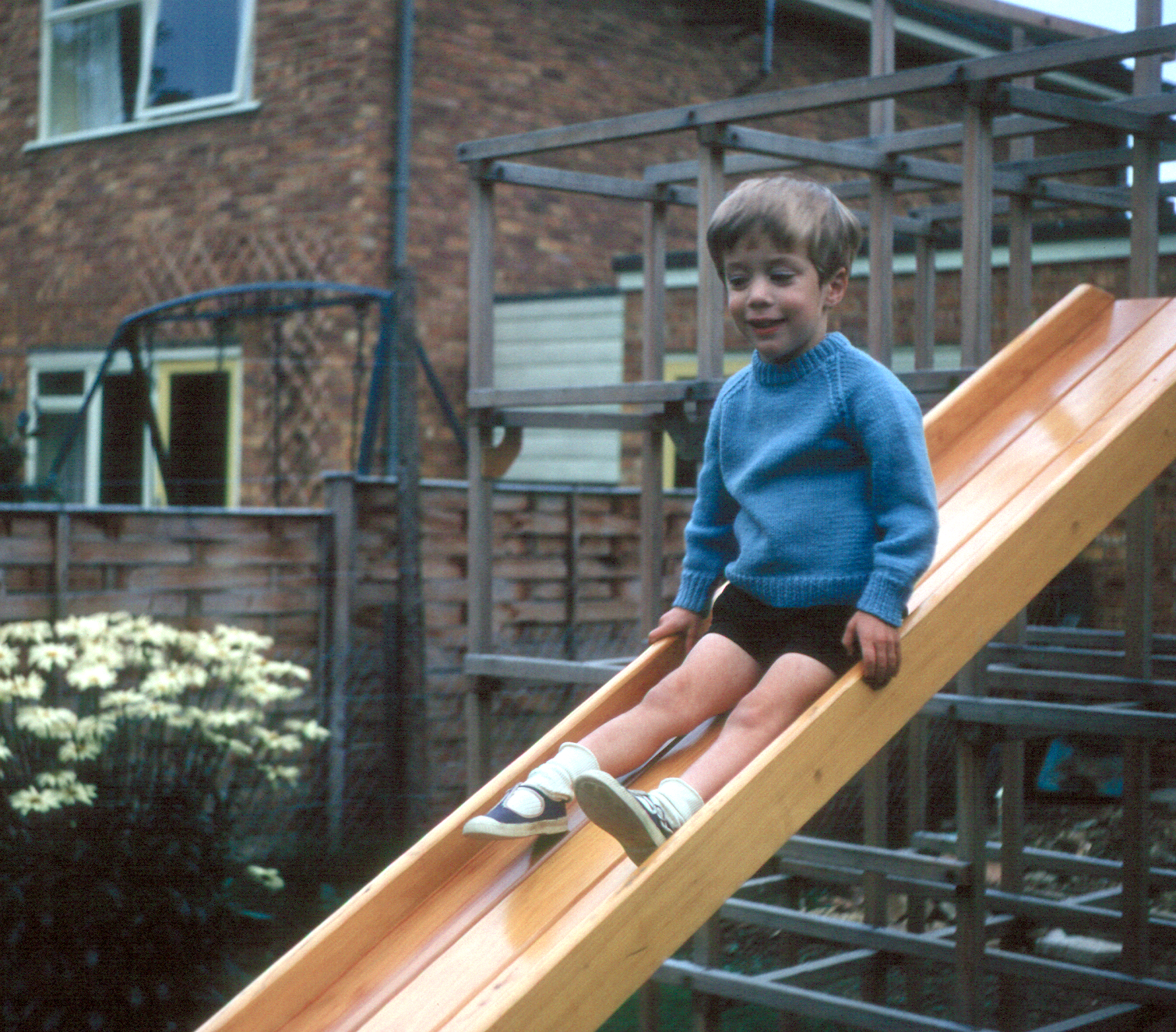 6801813k August 1968 - Jonathan on the slide at Bracknell. The climbing frame was made for the boys by Dad!