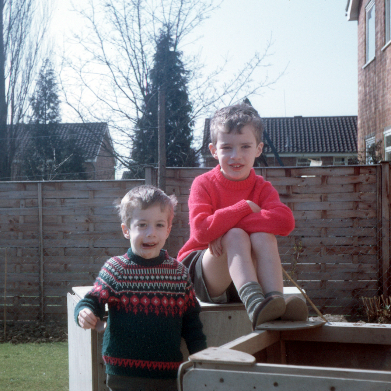 6901903k Spring 1969 - Simon and Jonathan with their boxes in the back garden at Bracknell. The boxes were made by Dad.