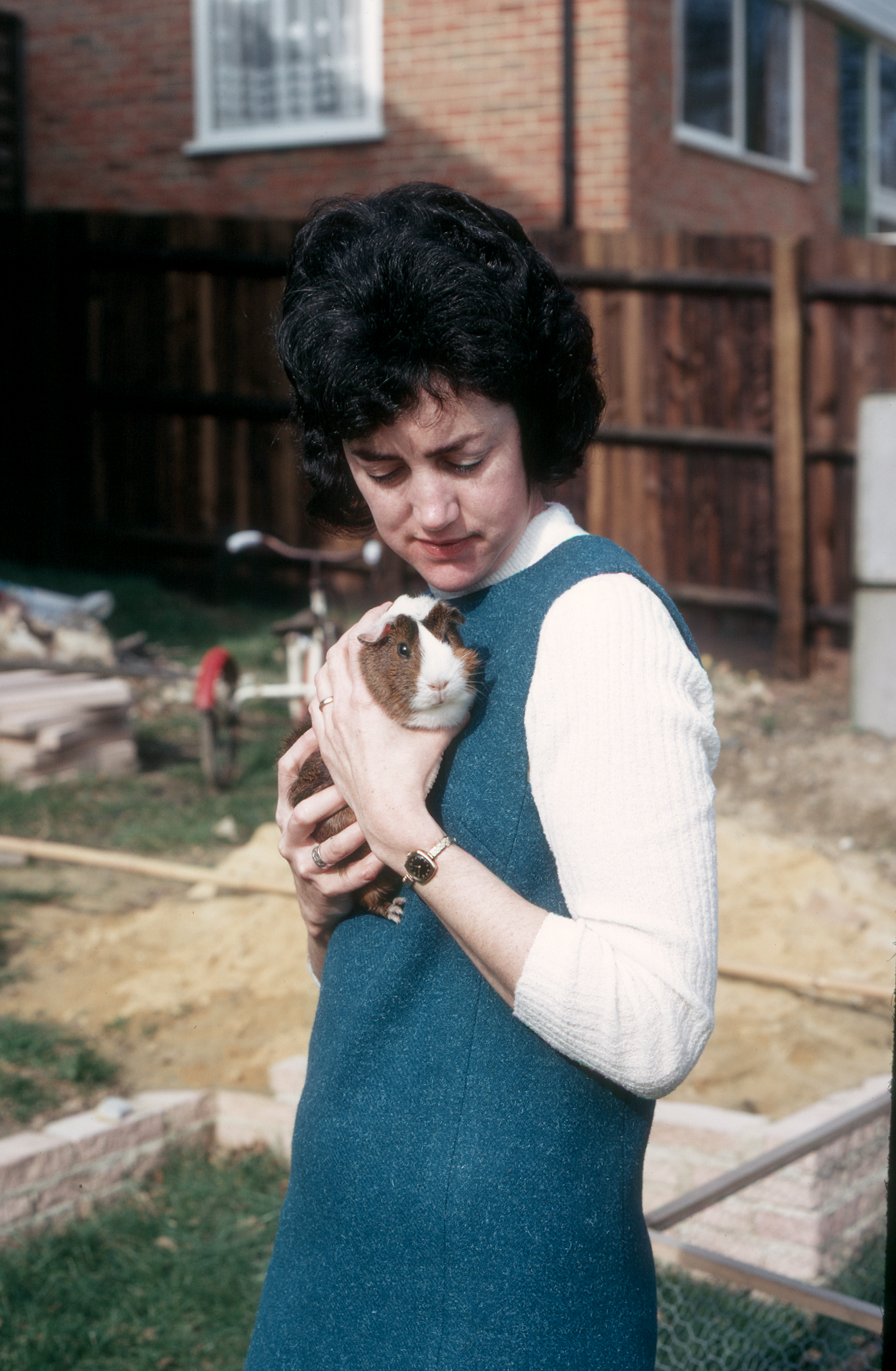 7202406k Early 1972 - Elizabeth holding Ginnie in the back garden.