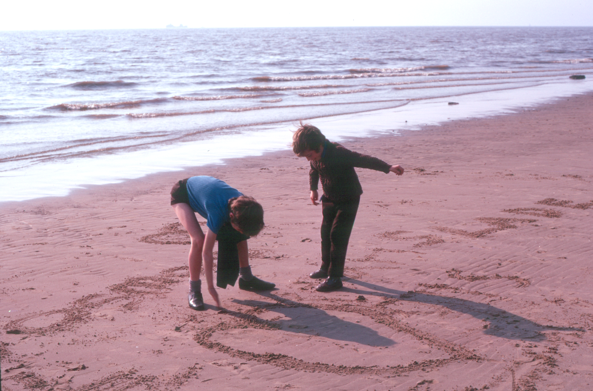 7303528k April 1973 - Sand writing on Crosby beach.