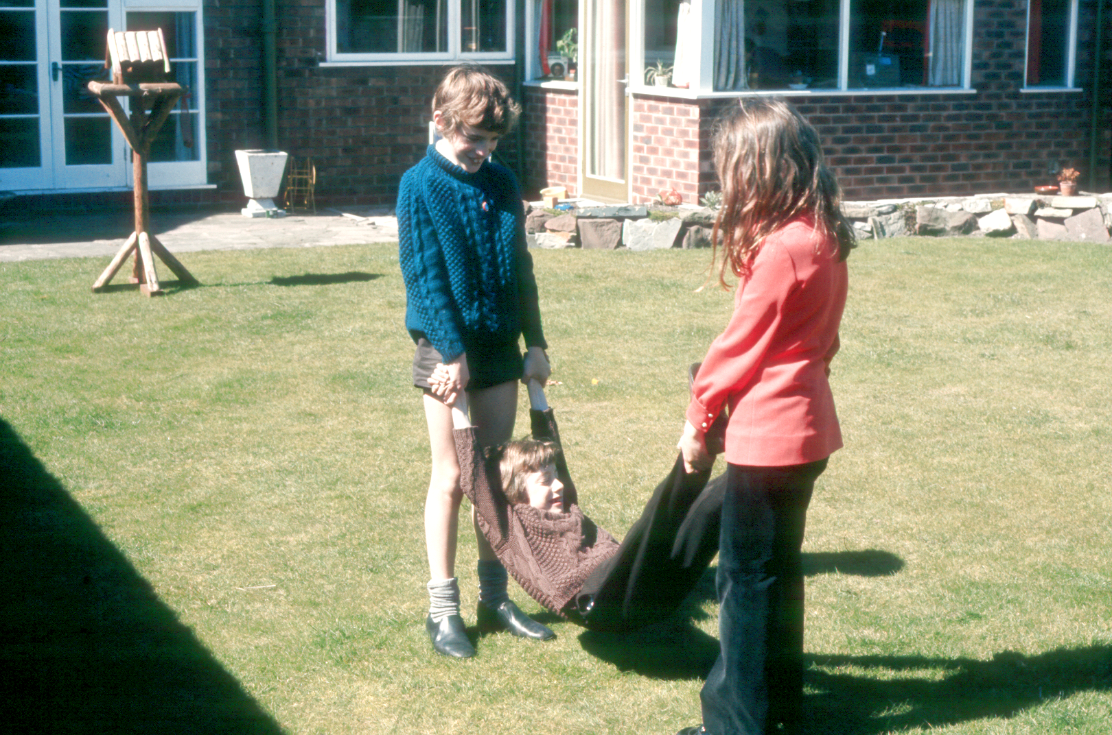 7303601k April 1973 - J being swung by Simon and Jo.