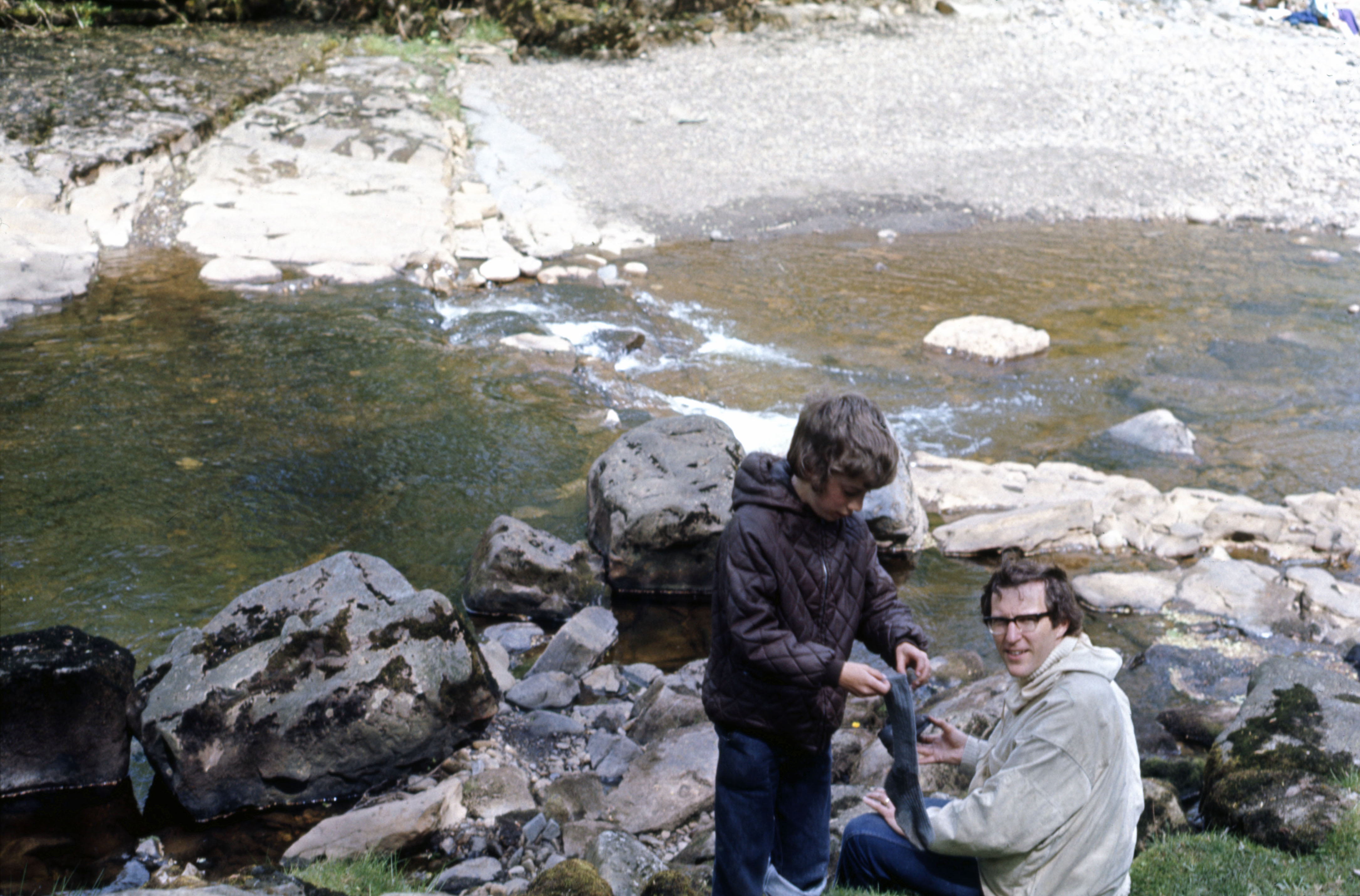 7404120 28 May 1974 - Jon got his feet wet while crossing the river over the stepping stones.