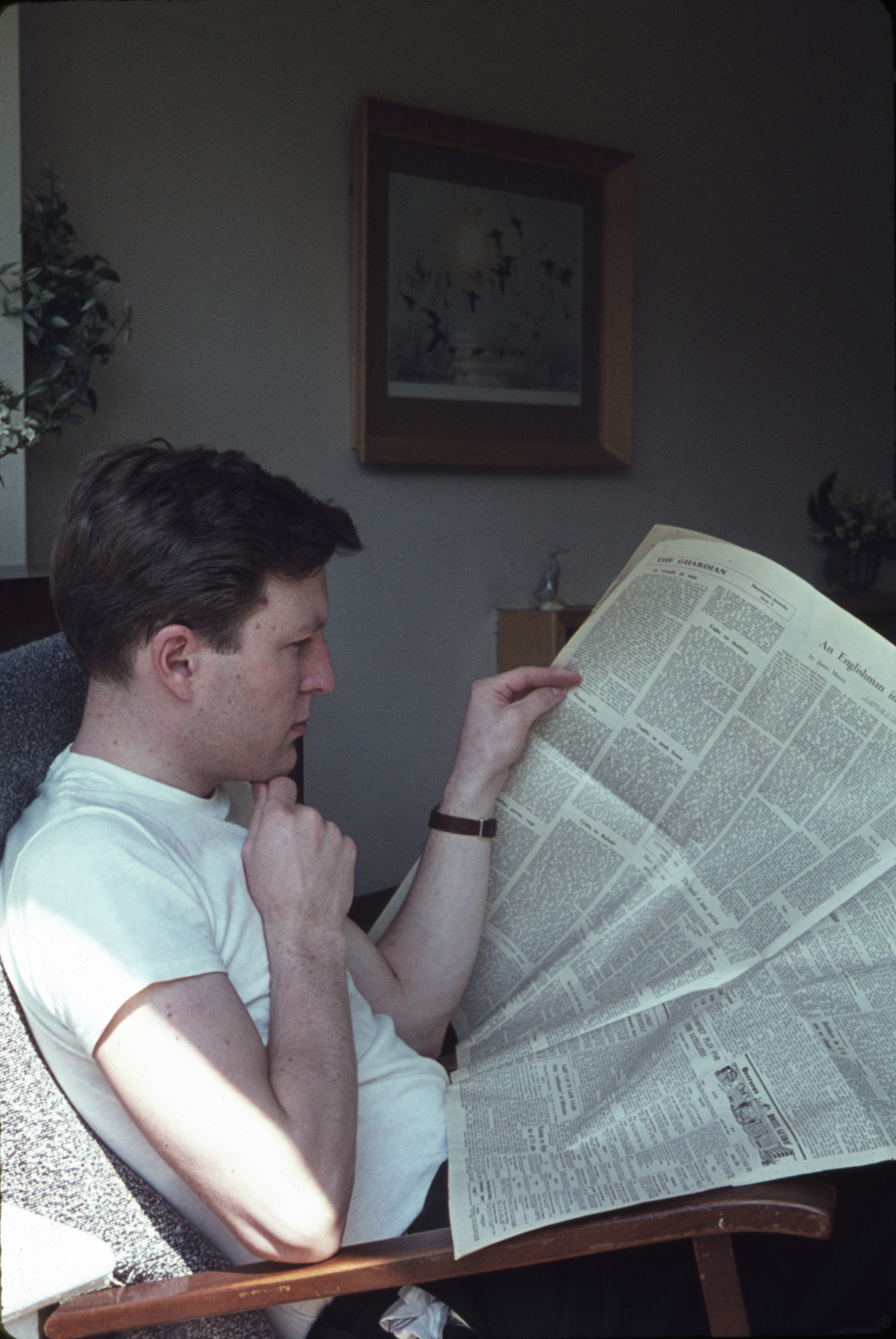 June 1962 Malcolm reading the Guardian in the living room at Hampton