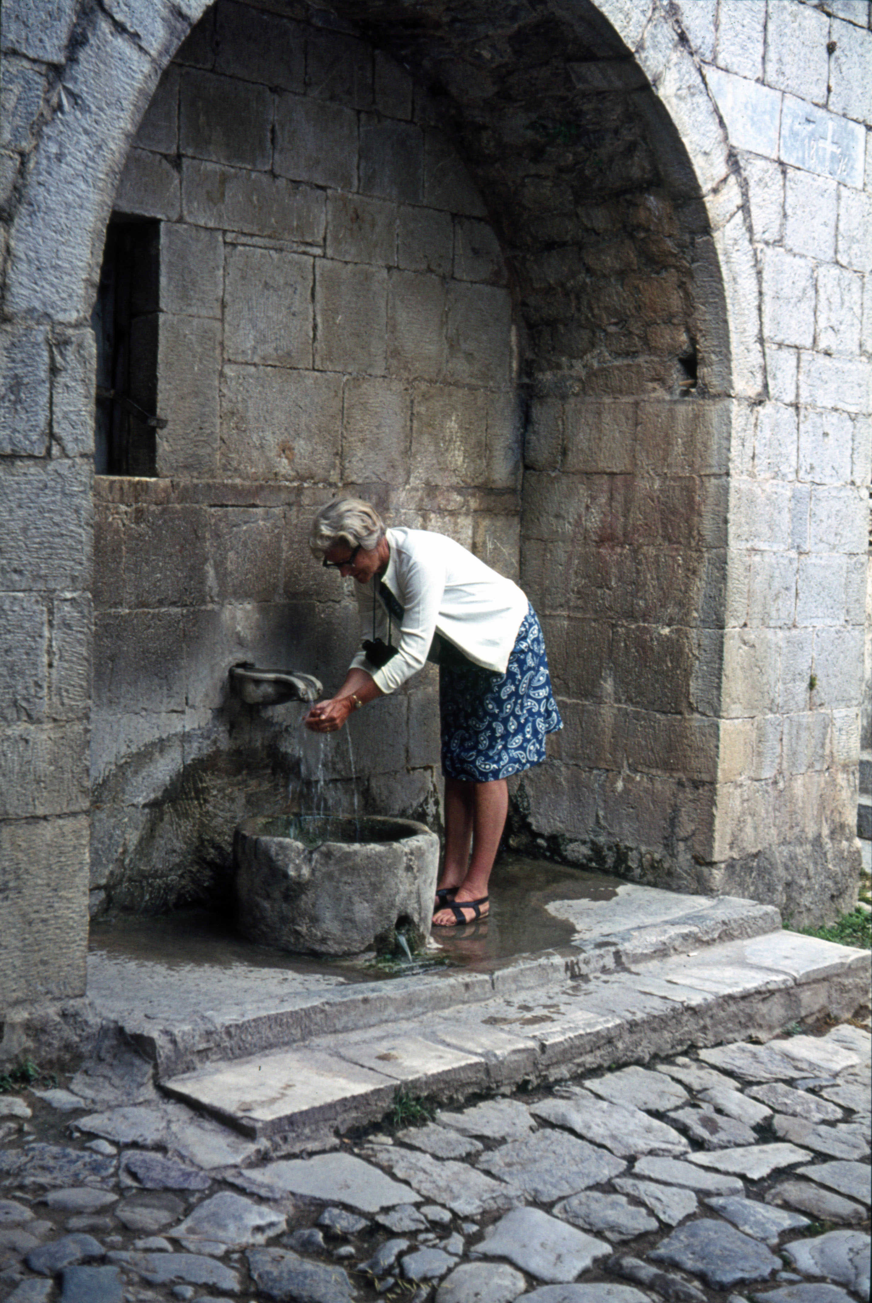 Summer 1965 Joan getting water from the Spring at Hosios Loukas Monastry in Greece