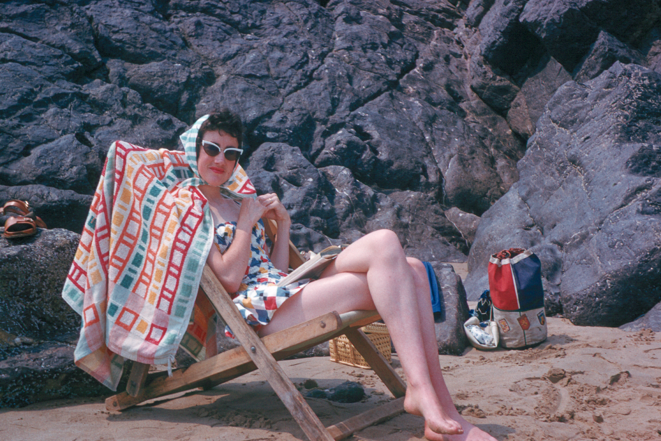 5900235s 25 July 1959 - Betty sheltering from the sun on Tenby beach during our honeymoon.